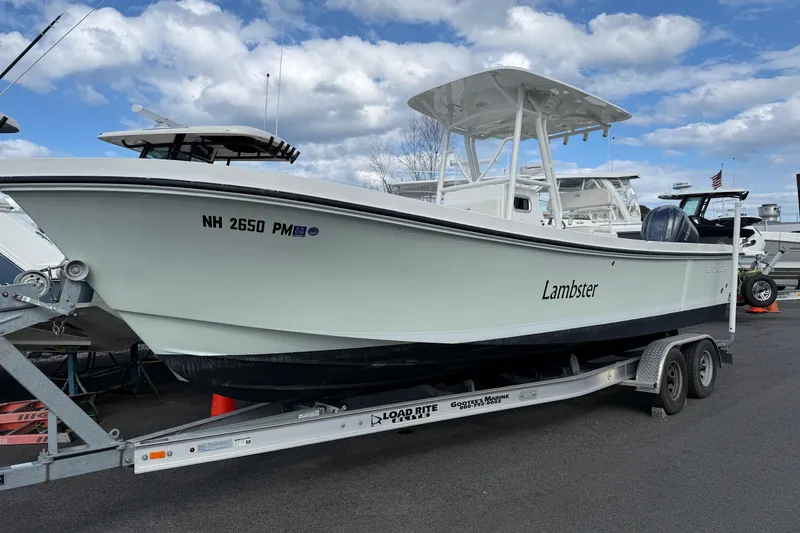 The Image of 2022 Steiger Craft 255 Tournament boat on trailer under cloudy sky. - 0