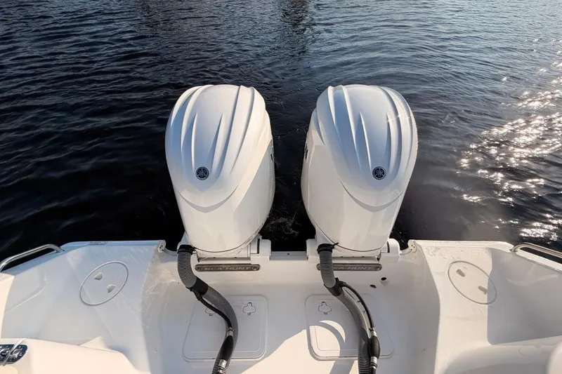 Slide: The Image of 2024 Sea Hunt Ultra 275 SE boat with dual outboard engines on water. - 13