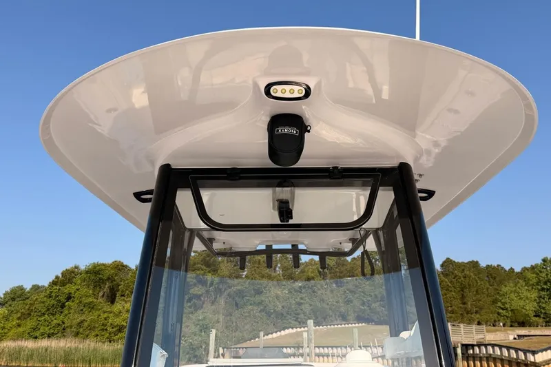 Slide: The Image of 2024 Sea Hunt Ultra 275 SE boat canopy and windshield, featuring sleek design and modern equipment. - 17