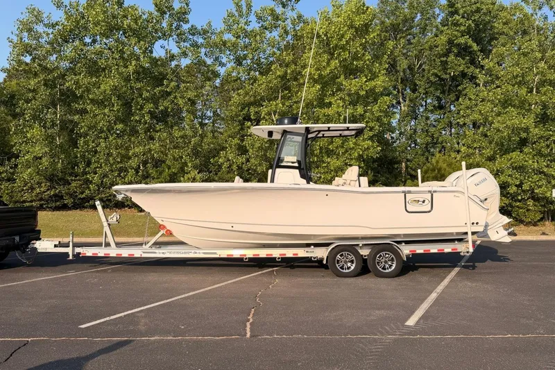 Slide: The Image of 2024 Sea Hunt Ultra 275 SE boat on trailer in parking lot. - 7