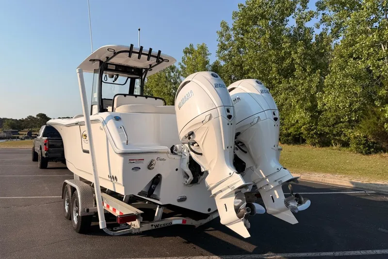 Slide: The Image of 2024 Sea Hunt Ultra 275 SE boat with dual Yamaha engines on a trailer. - 8