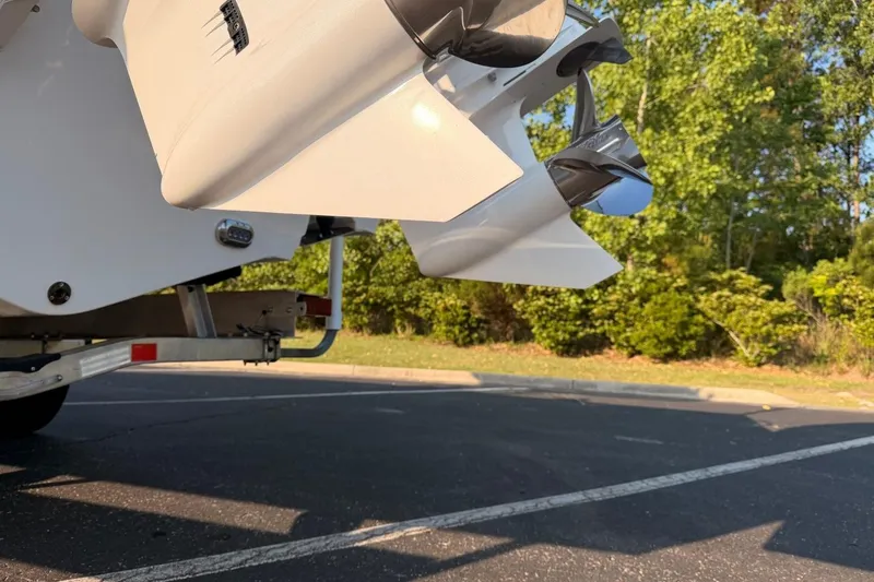 Slide: The Image of 2024 Sea Hunt Ultra 275 SE boat propeller and hull detail in a parking lot. - 9