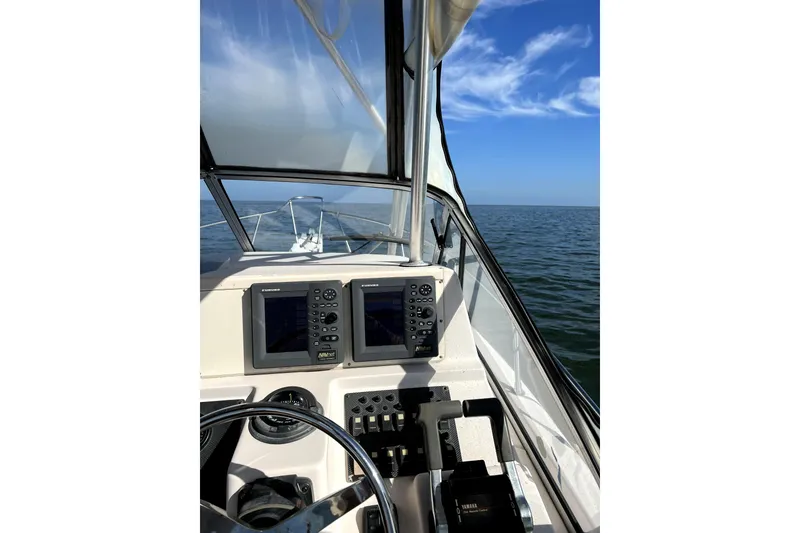 Slide: The Image of 2003 Grady-White Sailfish 282 boat dashboard with ocean view and clear blue sky. - 6