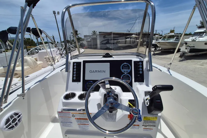 Slide: The Image of 2026 Robalo R180 Center Console boat dashboard with Garmin navigation system. - 11
