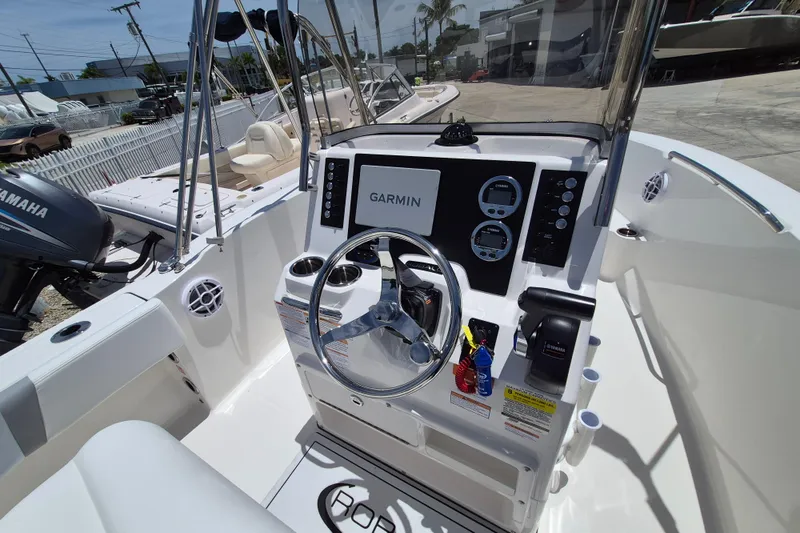 Slide: The Image of 2026 Robalo R180 Center Console boat interior with Garmin navigation system and Yamaha controls. - 12
