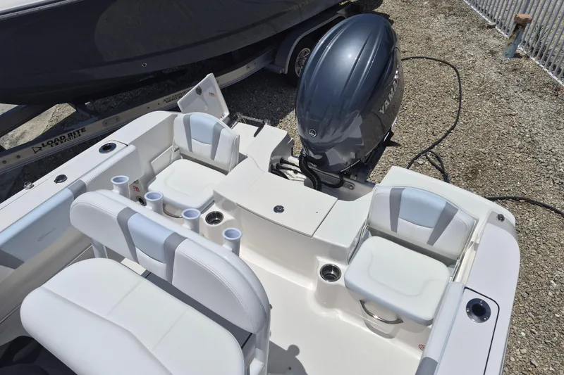 Slide: The Image of 2026 Robalo R180 Center Console boat interior with seating and Yamaha outboard motor. - 15