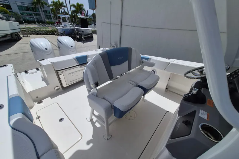 Slide: The Image of 2026 Robalo R250 Center Console boat interior with dual engines and modern seating. - 11