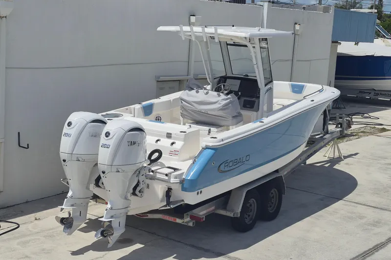 Slide: The Image of 2026 Robalo R250 Center Console boat with twin Yamaha 200 engines on a trailer. - 18