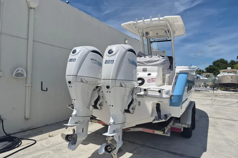 Slide: The Image of 2026 Robalo R250 Center Console boat with twin Yamaha 200 engines on a trailer. - 19