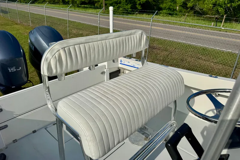 Slide: The Image of 1994 Regulator 23 Center Console boat with white cushioned seating and dual Yamaha engines. - 10