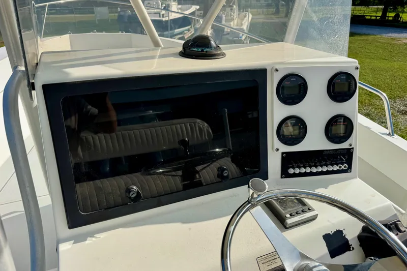 Slide: The Image of 1994 Regulator 23 Center Console dashboard with gauges and steering wheel in sunlight. - 12