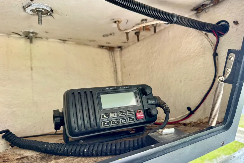 Slide: The Image of VHF marine radio inside a 1994 Regulator 23 Center Console boat compartment. - 13