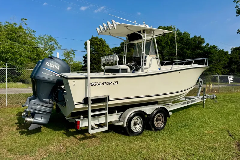 Slide: The Image of 1994 Regulator 23 Center Console boat on trailer with Yamaha outboard motor. - 3