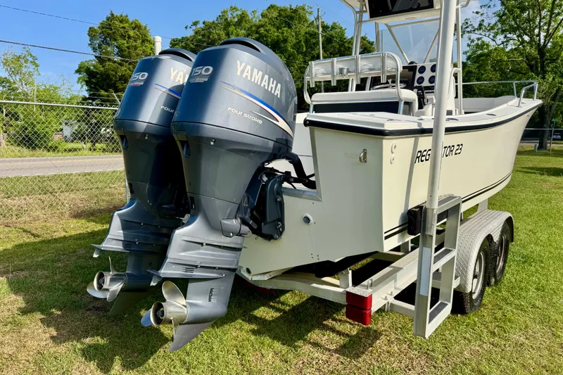 Slide: The Image of 1994 Regulator 23 Center Console boat with twin Yamaha 150 engines on a trailer. - 4