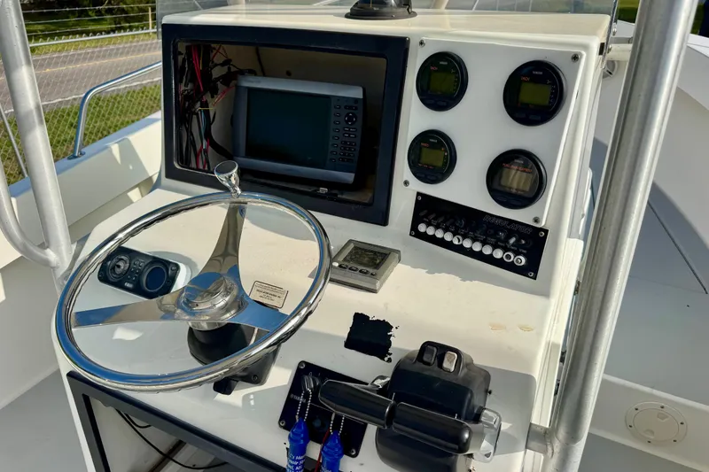 Slide: The Image of 1994 Regulator 23 Center Console boat dashboard with steering wheel and navigation instruments. - 7