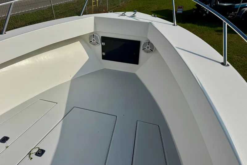 Slide: The Image of 1994 Regulator 23 Center Console boat interior with speakers and storage compartments. - 8