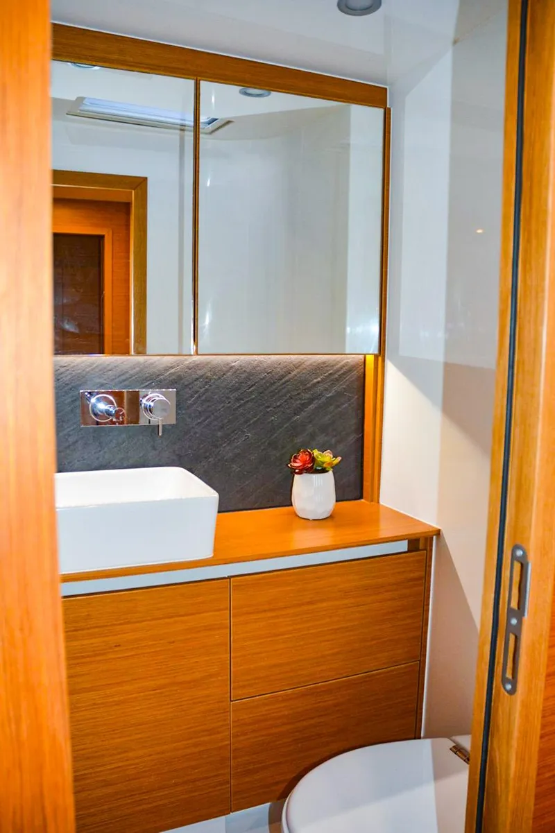 Slide: The Image of Luxurious bathroom interior on 2018 Hanse 675 yacht with modern sink and wooden cabinetry. - 11