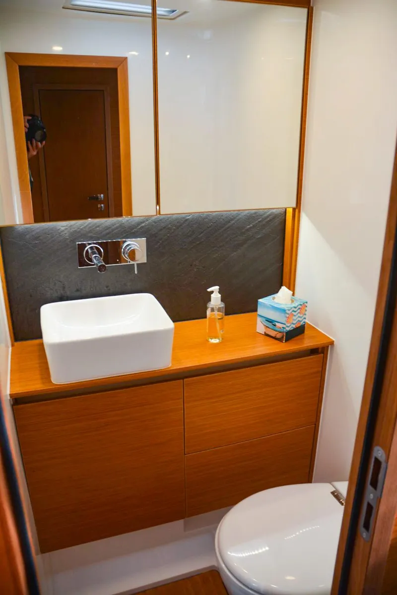 Slide: The Image of Modern bathroom in 2018 Hanse 675 yacht with sleek fixtures and wooden cabinetry. - 13