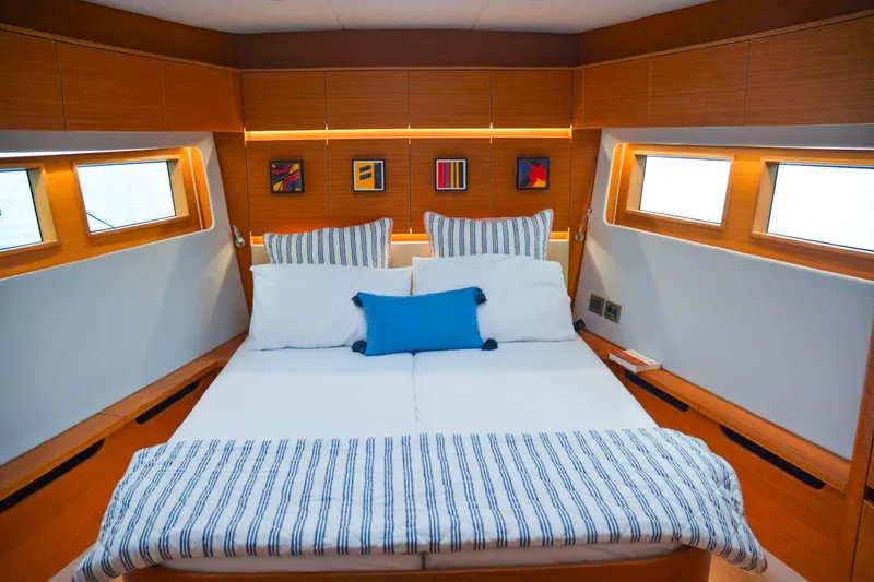 Slide: The Image of Luxurious 2018 Hanse 675 yacht bedroom with modern decor and ample natural light. - 15