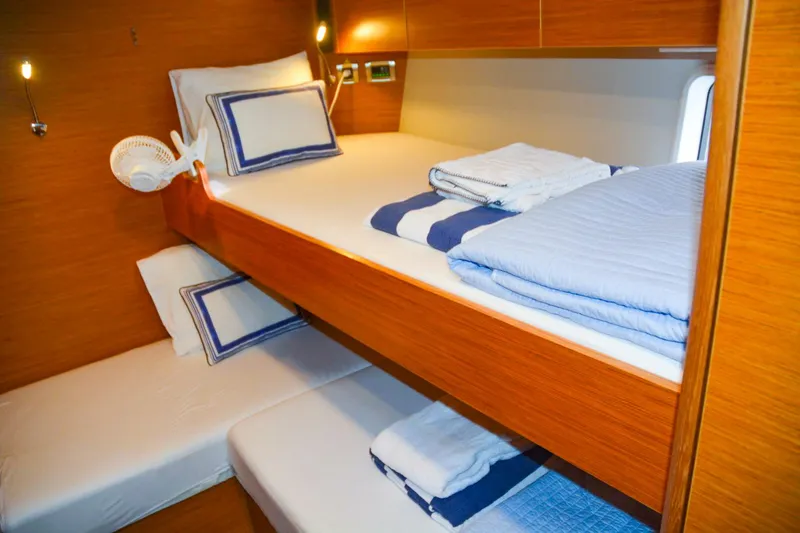 Slide: The Image of Luxurious 2018 Hanse 675 yacht cabin with cozy bunk beds and elegant bedding. - 16