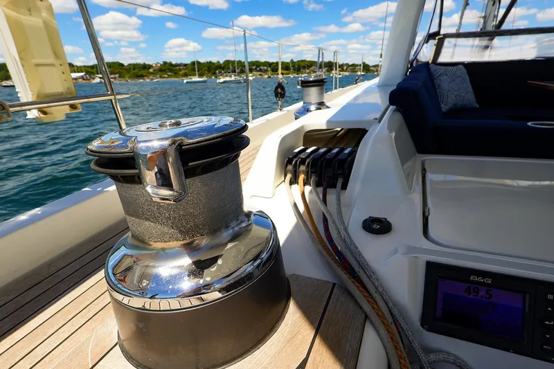 Slide: The Image of 2018 Hanse 675 yacht deck with winch, ropes, and navigation display. - 19