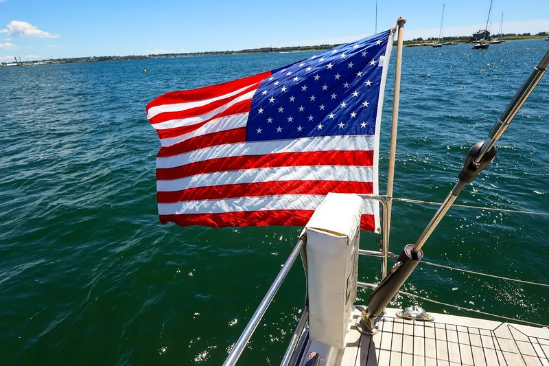 Slide: The Image of American flag on 2018 Hanse 675 yacht, sailing on a sunny day. - 21