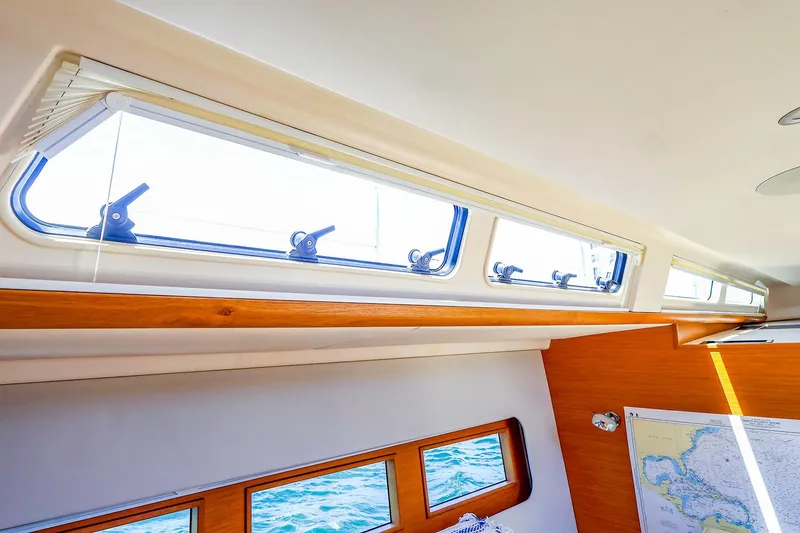 Slide: The Image of Interior view of 2018 Hanse 675 yacht, featuring sleek windows and nautical map. - 48