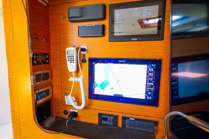 Slide: The Image of Control panel of a 2018 Hanse 675 yacht with navigation and communication equipment. - 51