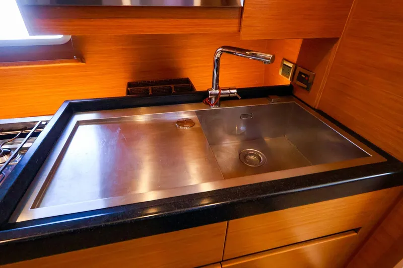 Slide: The Image of Modern kitchen sink in 2018 Hanse 675 yacht, featuring sleek stainless steel design. - 58