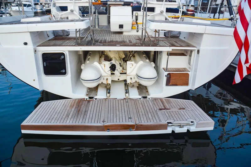 Slide: The Image of Hanse 675 yacht stern view with open garage, 2018 model, docked in marina. - 6