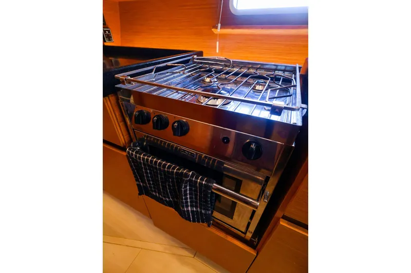 Slide: The Image of Stainless steel stove in 2018 Hanse 675 yacht kitchen with wooden cabinetry. - 60