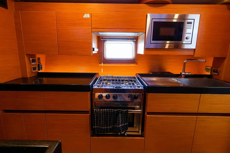 Slide: The Image of Modern kitchen in 2018 Hanse 675 yacht with stove, microwave, and sink. - 61