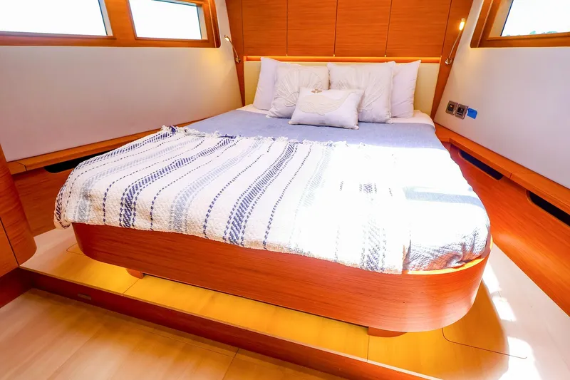 Slide: The Image of Luxurious cabin interior of 2018 Hanse 675 yacht with cozy bed and wooden finish. - 67