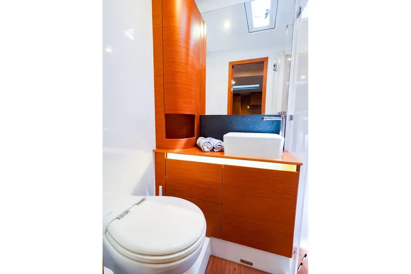 Slide: The Image of Luxurious bathroom interior of 2018 Hanse 675 yacht with modern fixtures and wooden cabinetry. - 68