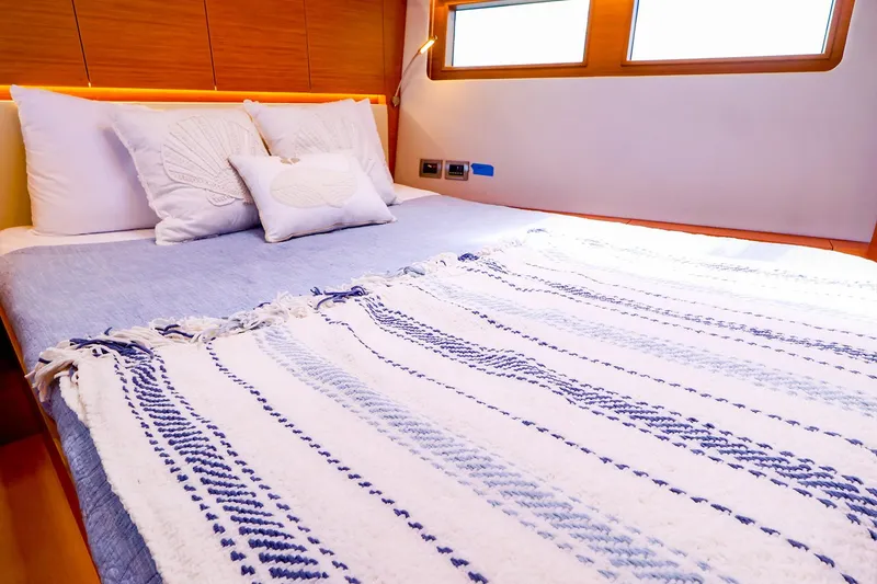 Slide: The Image of Luxurious cabin interior of 2018 Hanse 675 yacht with cozy bedding and decorative pillows. - 72