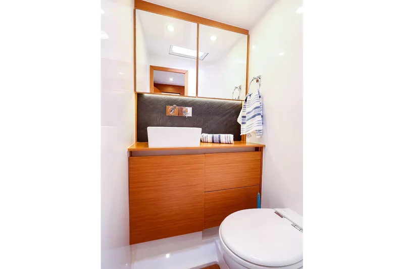 Slide: The Image of Modern bathroom interior on 2018 Hanse 675 yacht, featuring sleek wood cabinetry and elegant fixtures. - 74