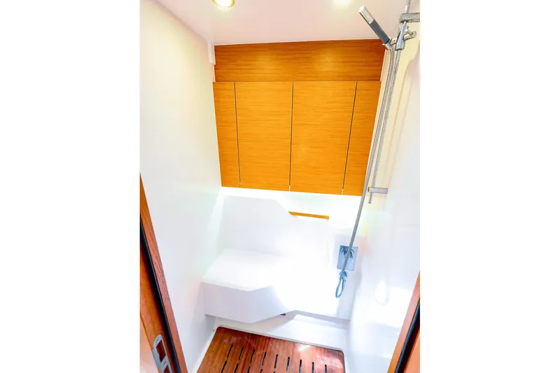 Slide: The Image of Luxurious shower area on 2018 Hanse 675 yacht with wooden accents and modern fixtures. - 75