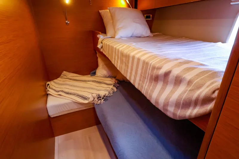 Slide: The Image of Cozy cabin interior of 2018 Hanse 675 yacht with bunk beds and warm lighting. - 78