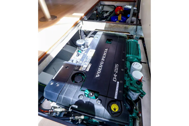 Slide: The Image of Engine compartment of a 2018 Hanse 675 yacht featuring a Volvo Penta D4-225 engine. - 79