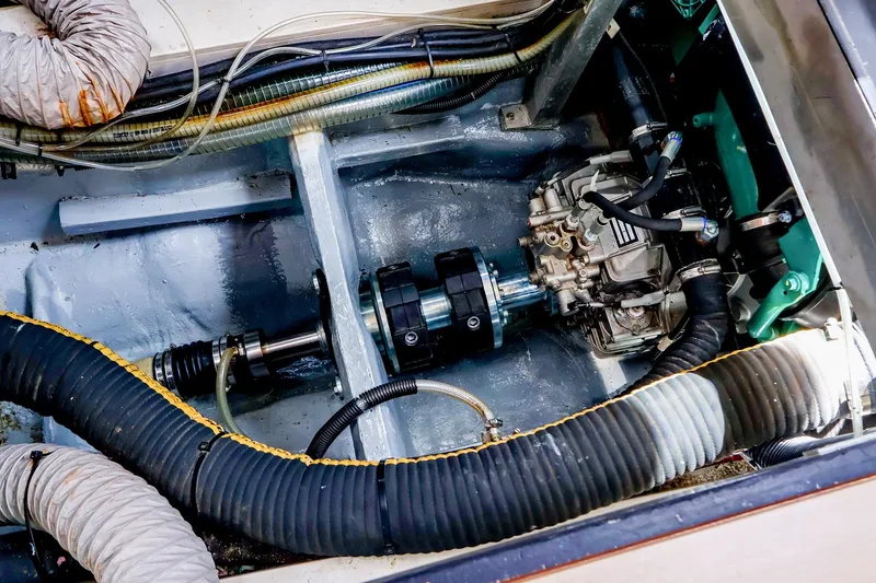 Slide: The Image of Engine compartment of a 2018 Hanse 675 yacht, showcasing mechanical components and hoses. - 80