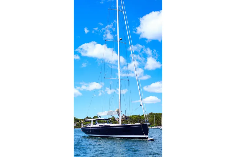 Slide: The Image of 2018 Hanse 675 yacht sailing on a sunny day with blue sky and clouds. - 83