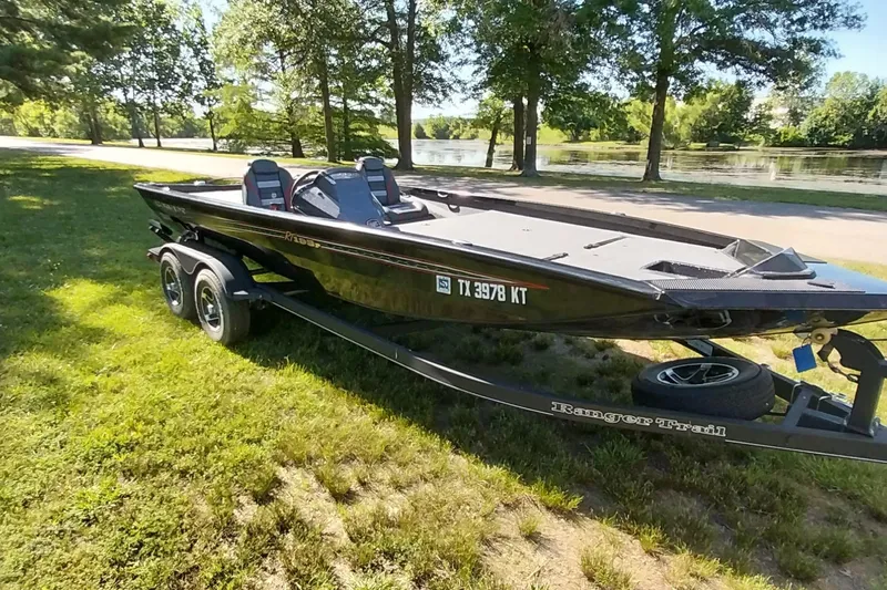 The Image of 2023 Ranger RT198P boat on trailer by a scenic lake. - 0