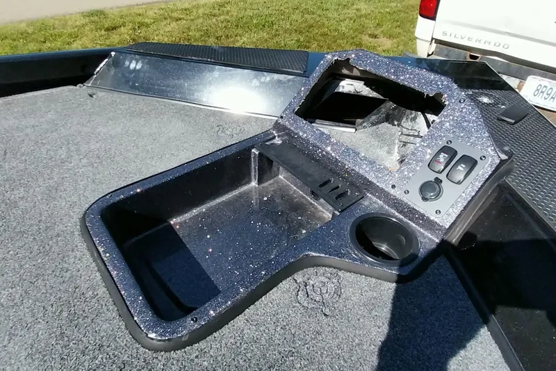 Slide: The Image of 2023 Ranger RT198P boat console with glitter finish, featuring control switches and cup holder. - 16