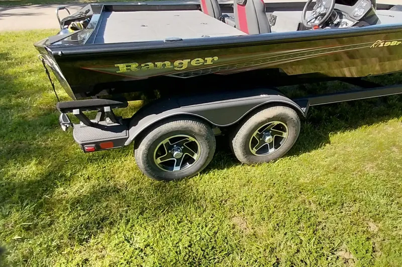 Slide: The Image of 2023 Ranger RT198P boat on trailer, parked on grass. - 19