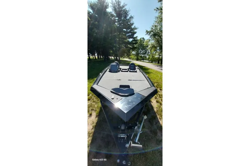 Slide: The Image of 2023 Ranger RT198P boat on grassy area, surrounded by trees and sunlight. - 26