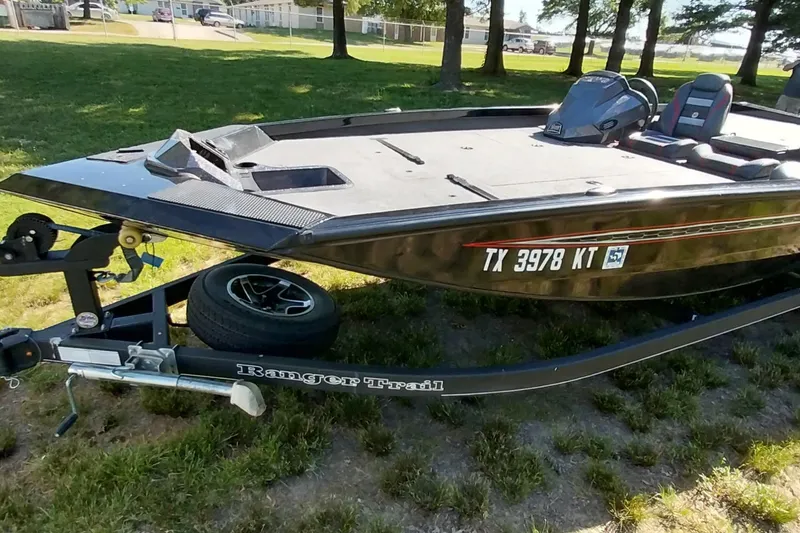 Slide: The Image of 2023 Ranger RT198P boat on trailer, parked on grass, with visible registration number. - 28