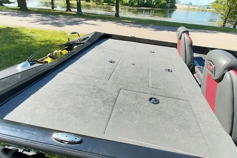 Slide: The Image of 2023 Ranger RT198P boat deck with seating, near a scenic lakeside view. - 4
