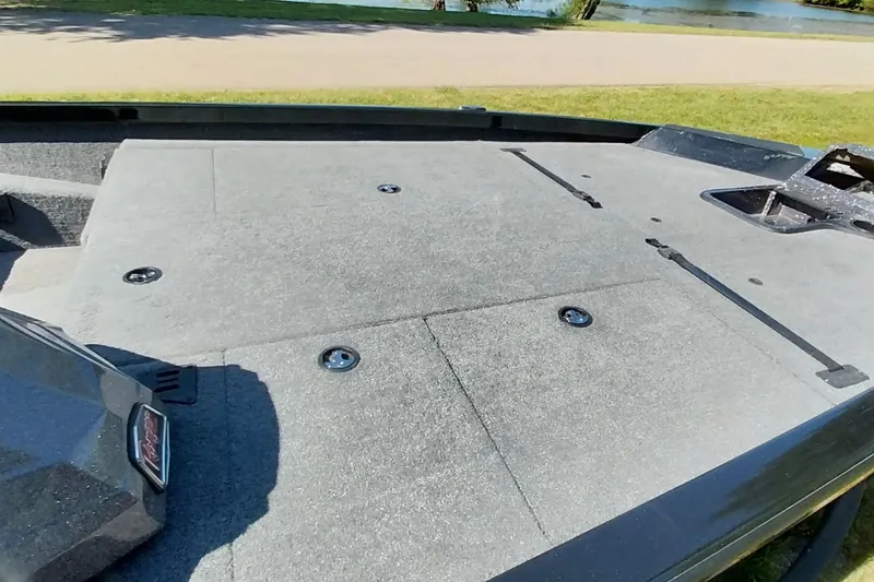 Slide: The Image of 2023 Ranger RT198P boat deck with storage compartments, near a lake. - 6