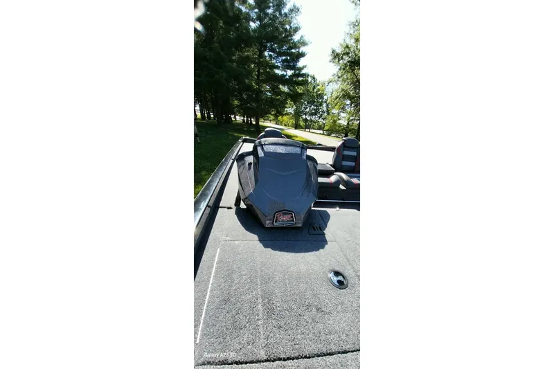 Slide: The Image of 2023 Ranger RT198P boat deck with seating, surrounded by trees and sunlight. - 7