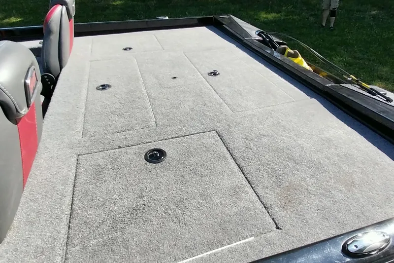 Slide: The Image of 2023 Ranger RT198P boat deck with carpeted storage compartments and seating. - 9